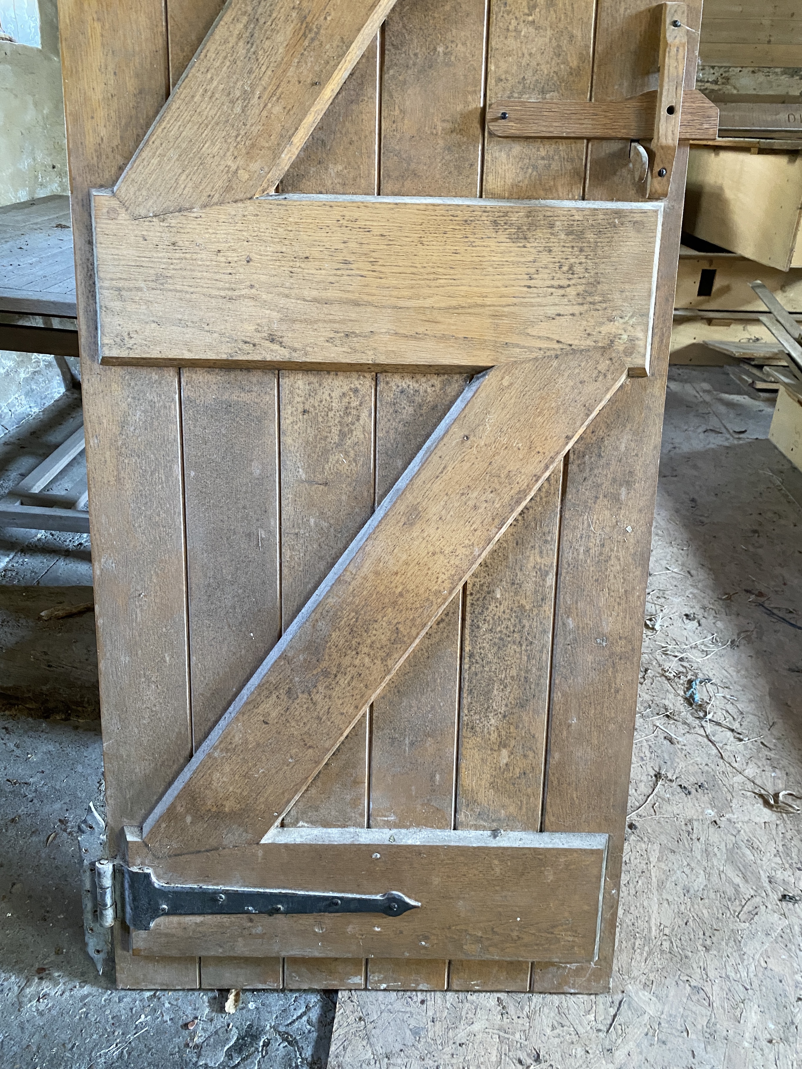 Three solid oak ledged and braced doors, 210 x 58.5cm; 204 x 44.5cm and 95 x 72cm, and a double sided panelled solid oak door, 200 x 64cm (4)